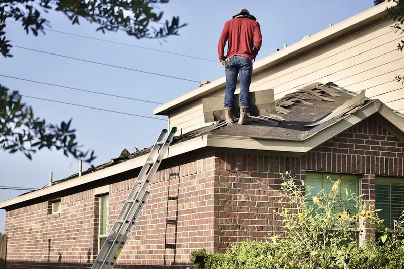 Professional roofer working on a residential roof in Summits Edge